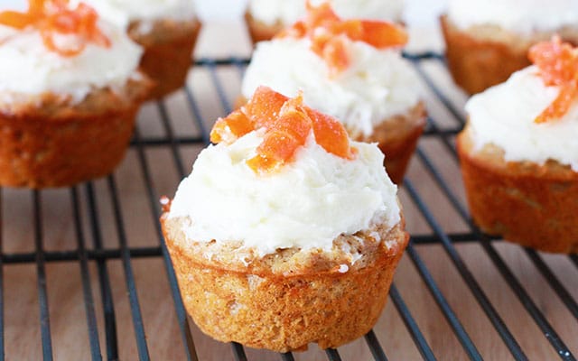 close up of a carrot cake muffin on a cooling rack