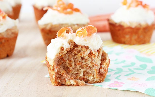 closeup of a carrot cake muffin with a bite taken out